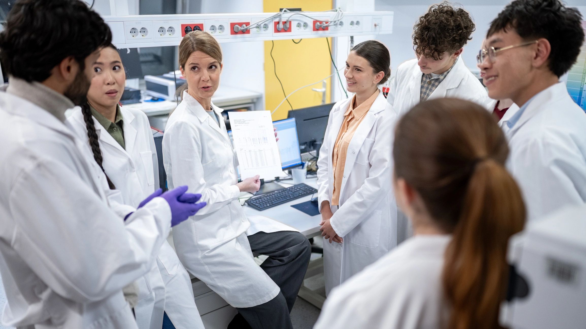 Pharmaceutical laboratory team collaborating in a modern lab